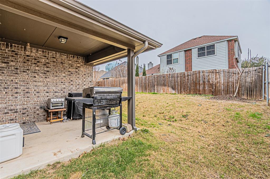 7201 Windy Ridge Drive Fort Worth, TX 76123 - Photo 32 of 36 a patio with table and chairs