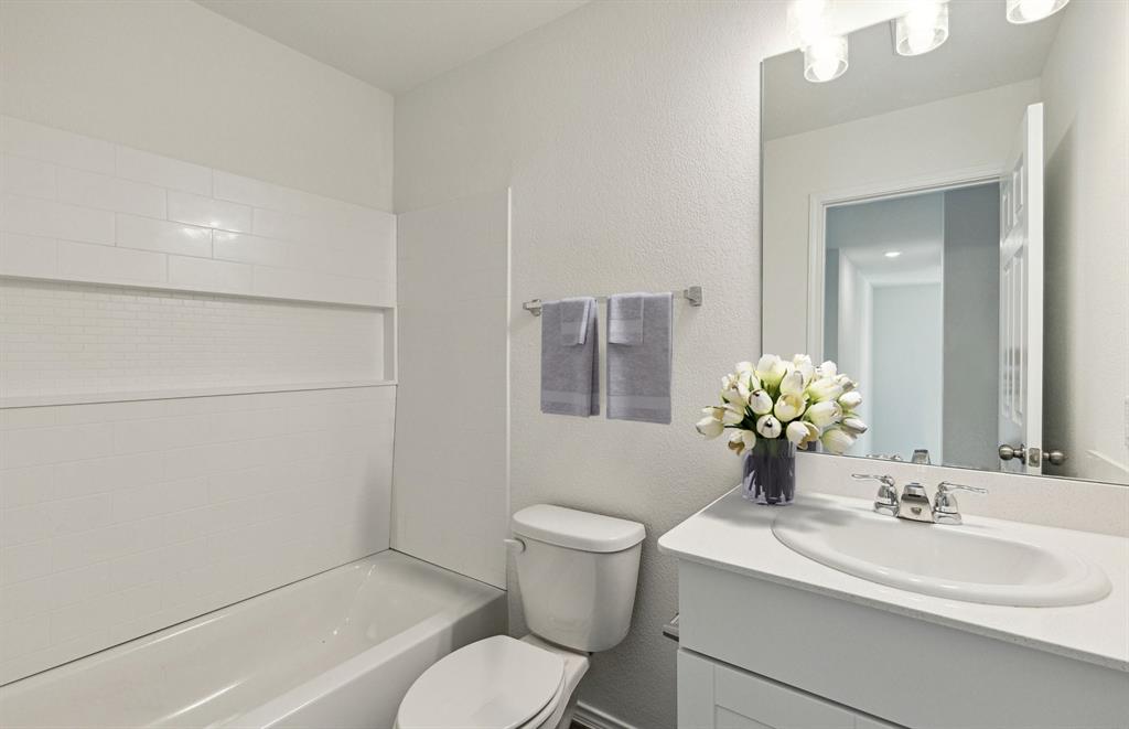 2305 Bay Laurel Lane Forney, TX 75126 - Photo 4 of 9 a bathroom with a toilet sink vanity granite and mirror