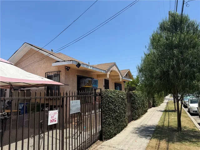 a view of a house with entrance stairs and a garden