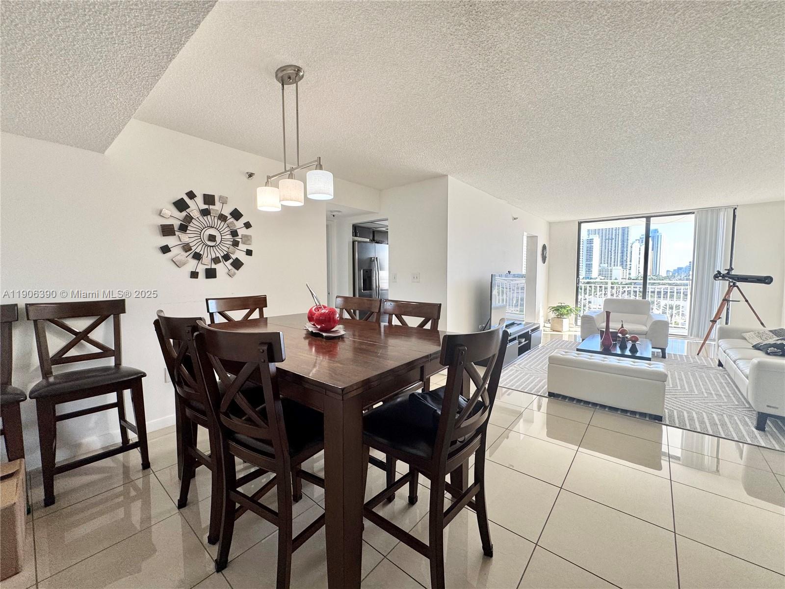 210 174th Street, Unit 1002 Sunny Isles Beach, FL 33160 - Photo 12 of 34 a dining room with furniture and window