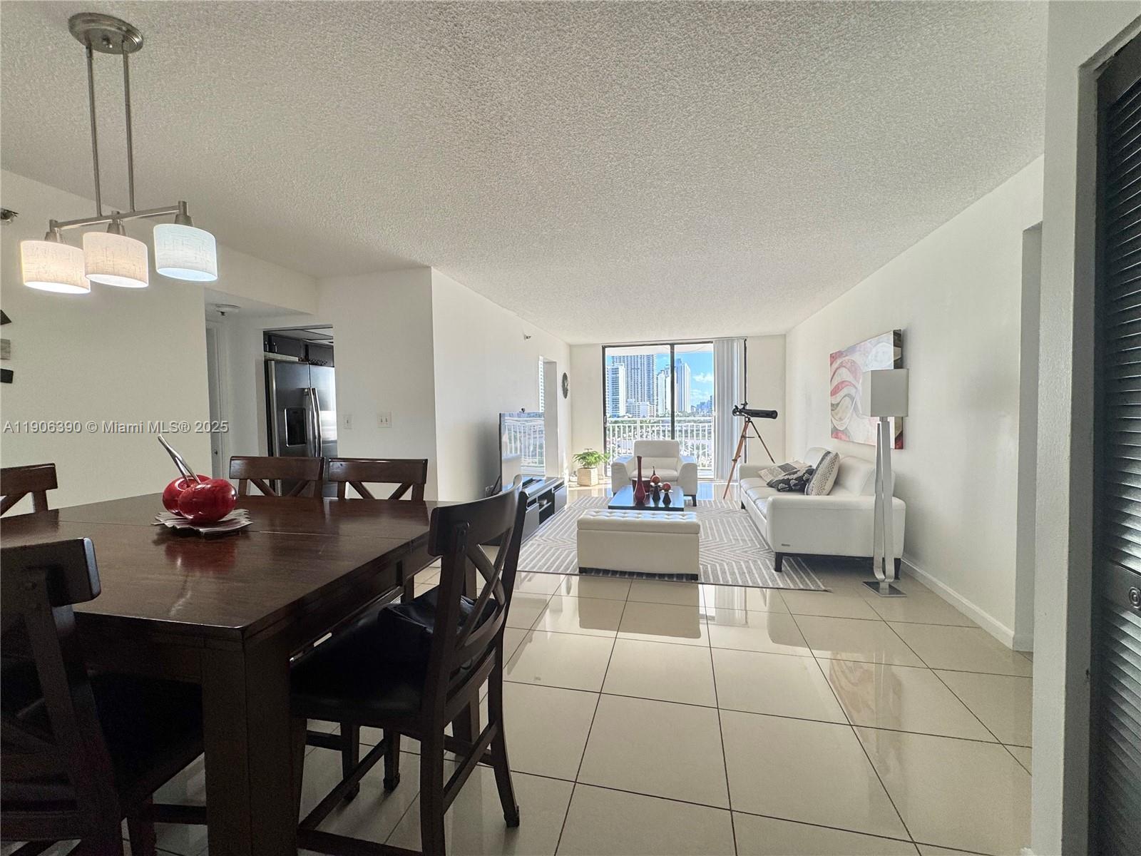 210 174th Street, Unit 1002 Sunny Isles Beach, FL 33160 - Photo 13 of 34 a living room with furniture and a dining table