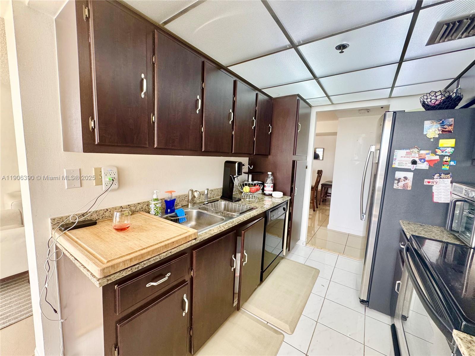 210 174th Street, Unit 1002 Sunny Isles Beach, FL 33160 - Photo 18 of 34 a kitchen that has a sink a stove and a refrigerator