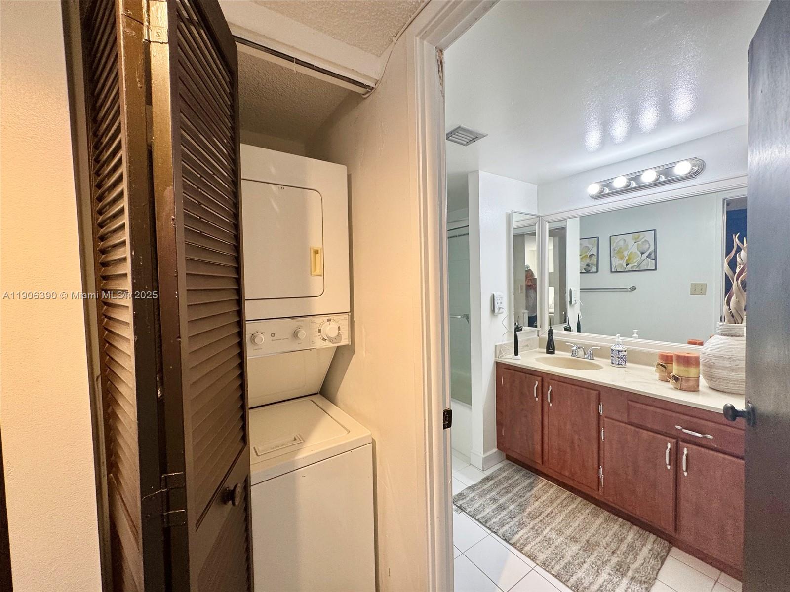 210 174th Street, Unit 1002 Sunny Isles Beach, FL 33160 - Photo 27 of 34 a kitchen with a refrigerator and sink
