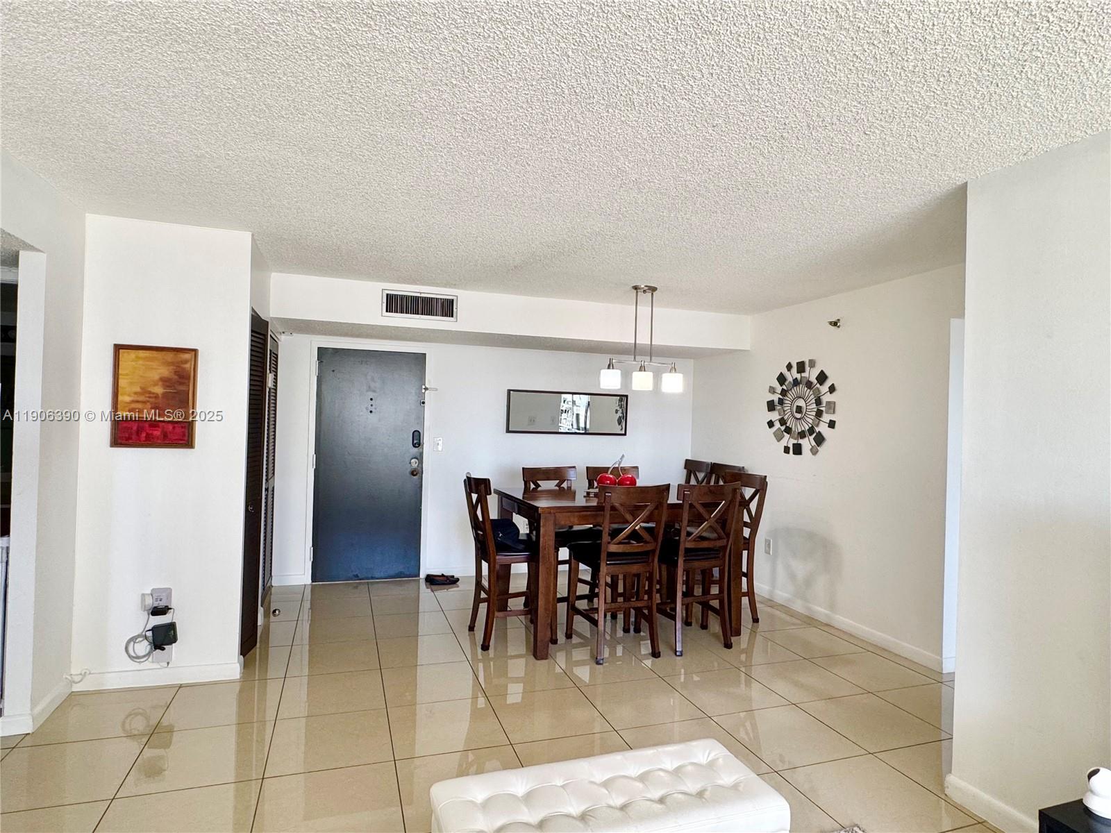210 174th Street, Unit 1002 Sunny Isles Beach, FL 33160 - Photo 28 of 34 a view of a dining room with furniture