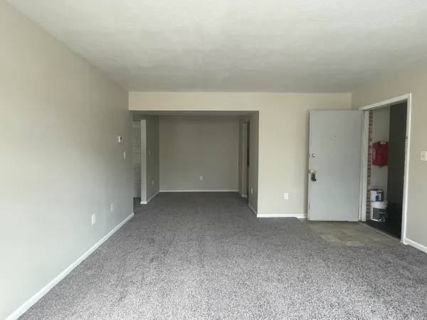 a view of an empty room and closet area