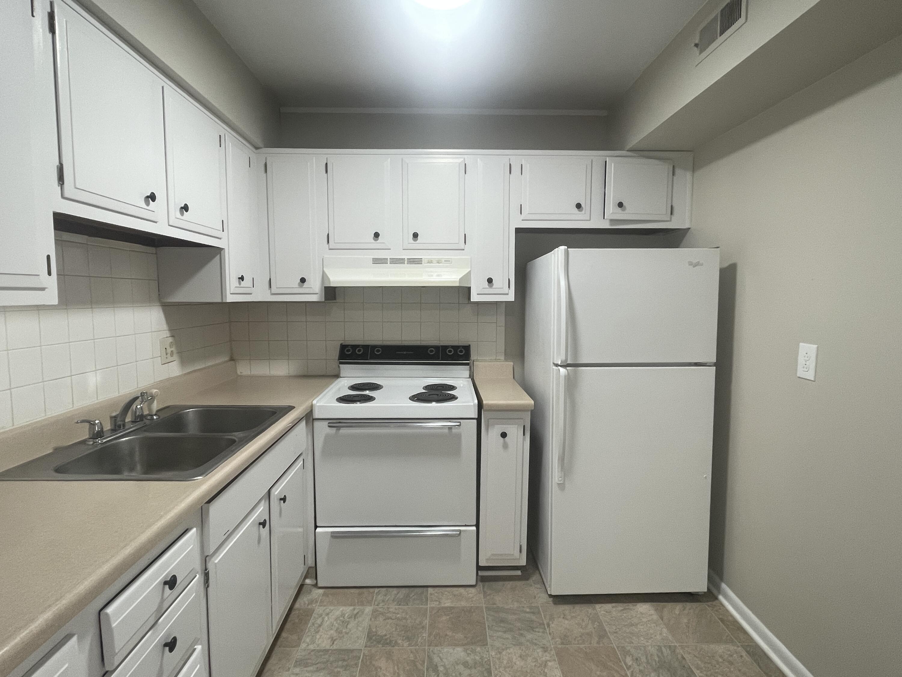 729 Townside Road Southwest, Unit 35 Roanoke, VA 24014 - Photo 3 of 6 a kitchen with refrigerator a stove a sink and cabinets