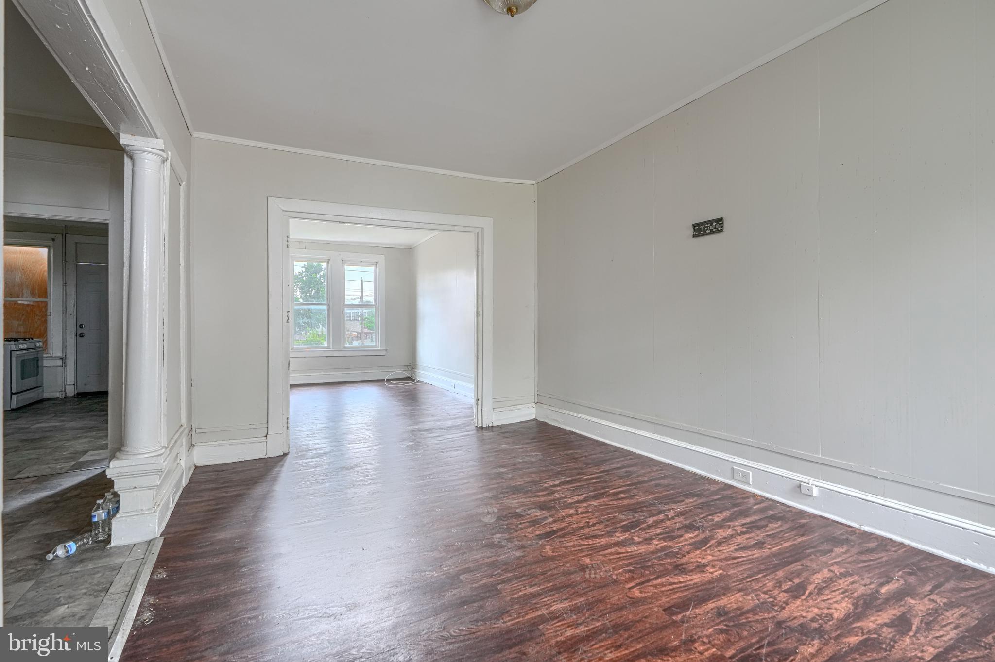 4806 Reisterstown Road Baltimore, MD 21215 - Photo 6 of 34 a view of an empty room with wooden floor and a window