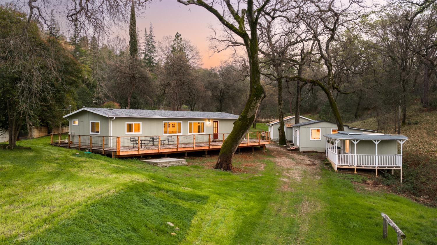 a view of a house with a yard and sitting area