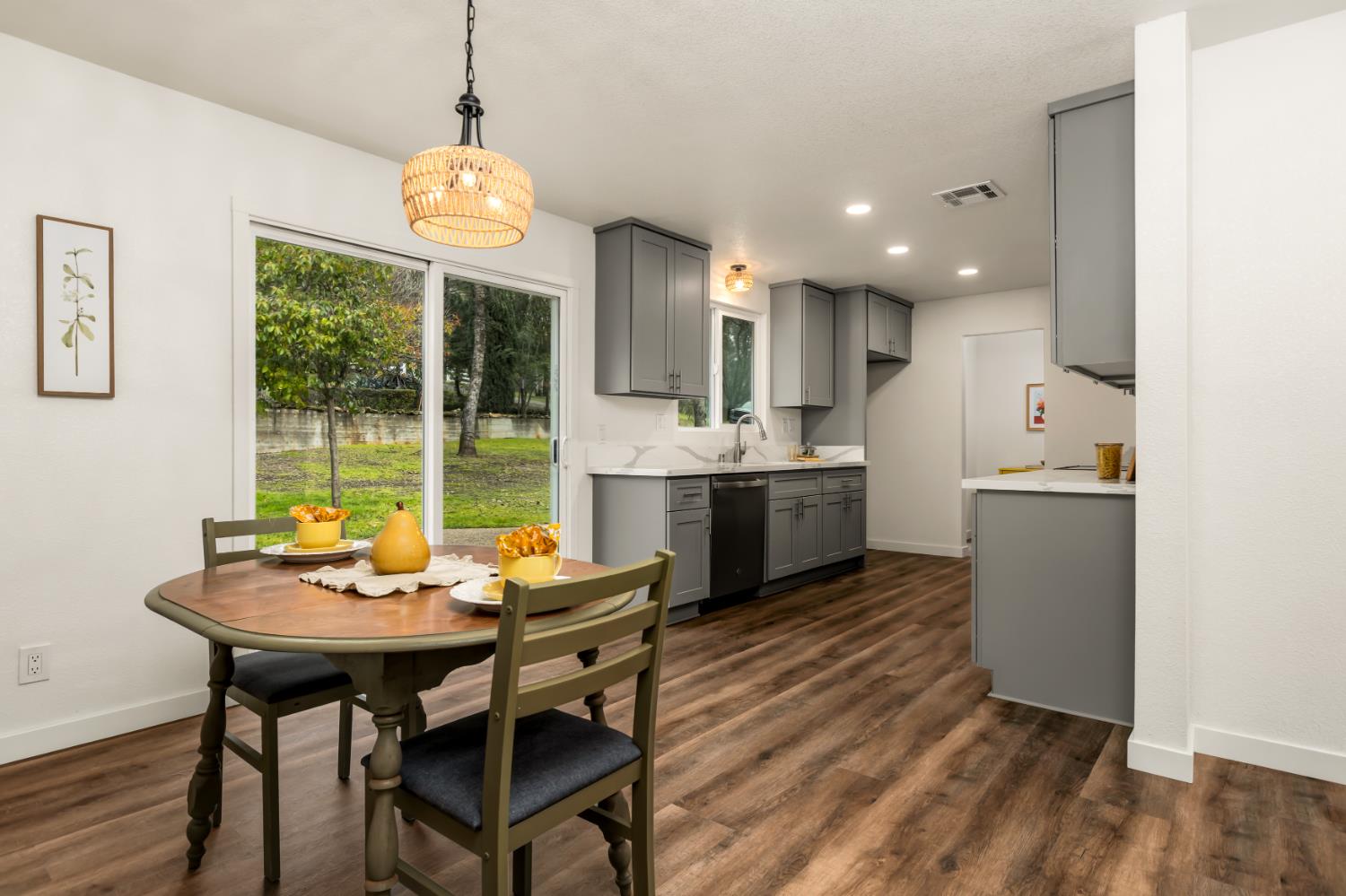 16098 Wild Oak Ranch Road Grass Valley, CA 95949 - Photo 13 of 45 a kitchen with a dining table chairs and chandelier