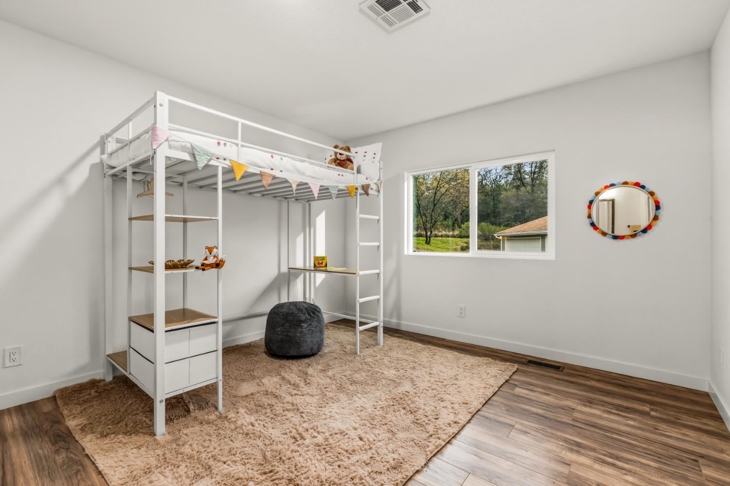 16098 Wild Oak Ranch Road Grass Valley, CA 95949 - Photo 27 of 45 a bedroom with furniture and a window