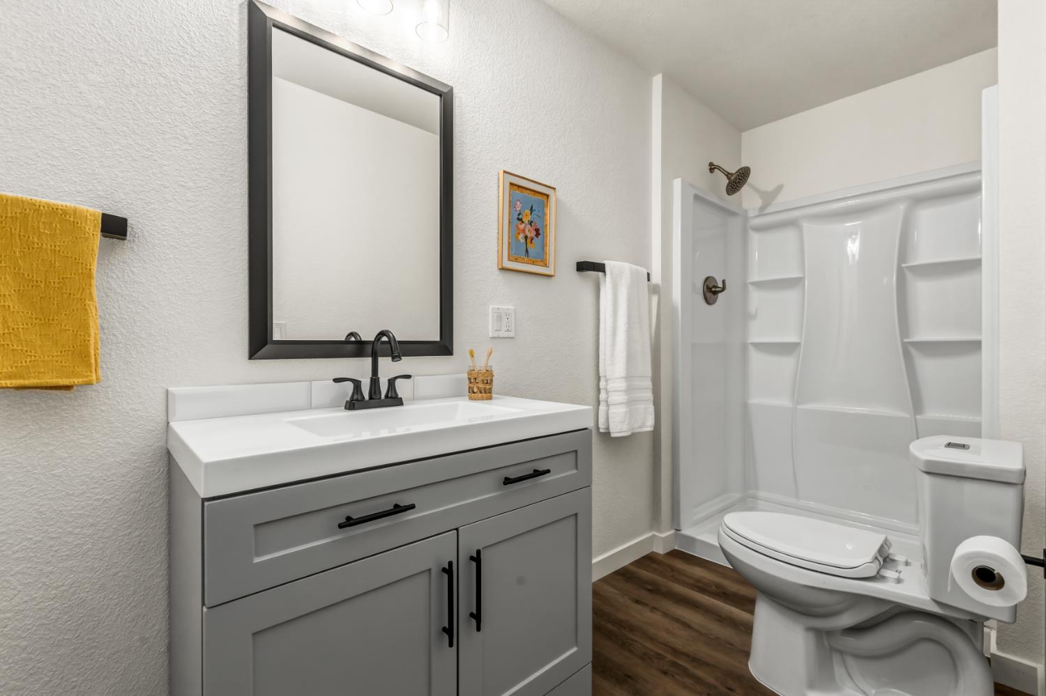 16098 Wild Oak Ranch Road Grass Valley, CA 95949 - Photo 28 of 45 a bathroom with a sink toilet a mirror and shower