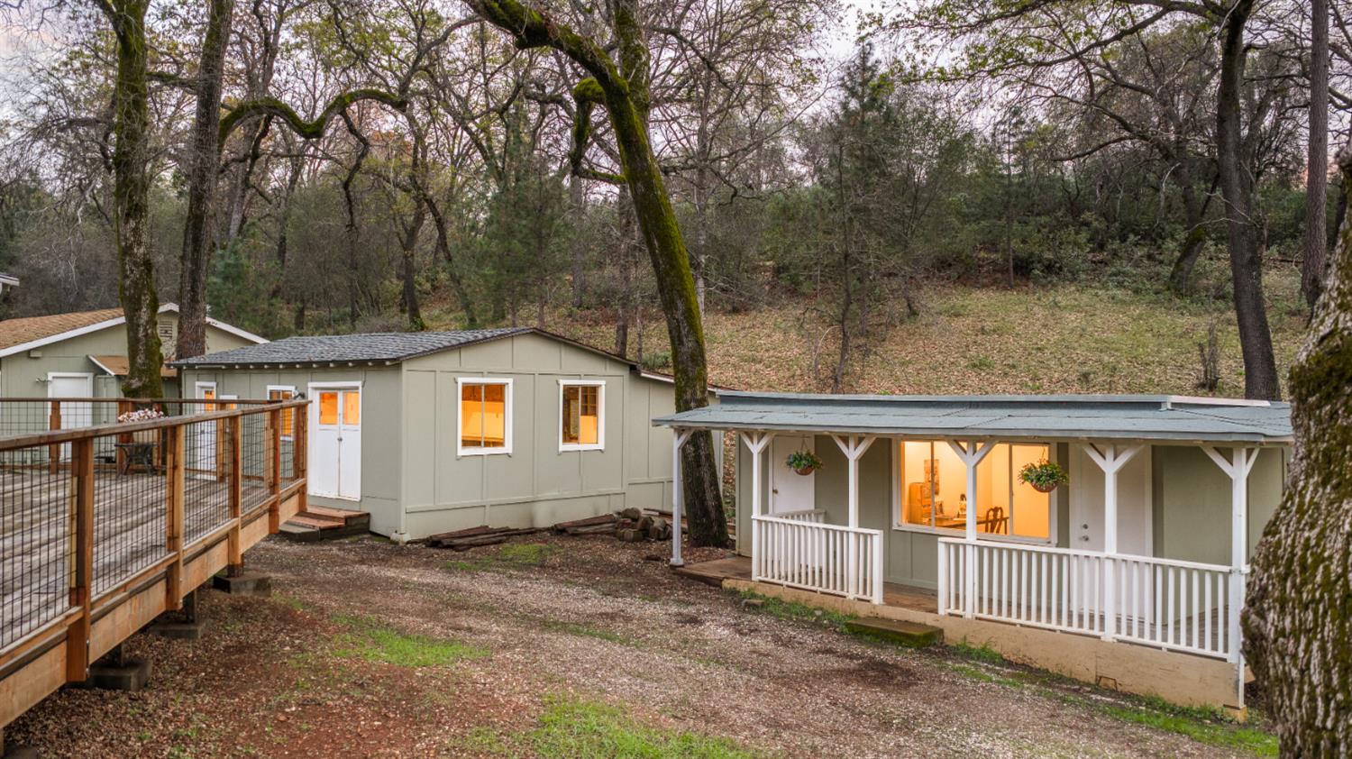 16098 Wild Oak Ranch Road Grass Valley, CA 95949 - Photo 30 of 45 front view of house with large trees and wooden fence