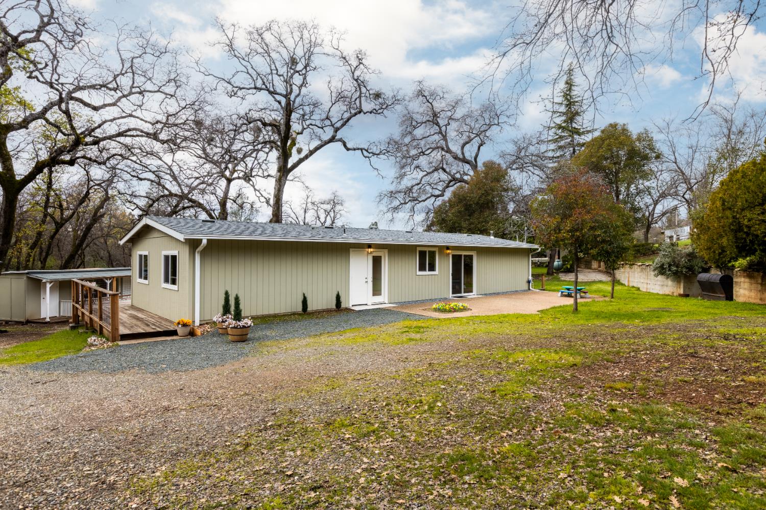 16098 Wild Oak Ranch Road Grass Valley, CA 95949 - Photo 7 of 45 a front view of a house with a yard and trees