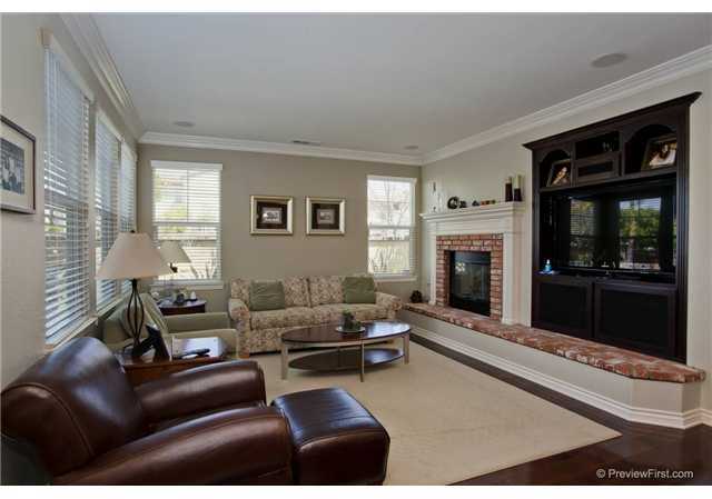 2681 Paradise Road Carlsbad, CA 92009 - Photo 13 of 23 Just opposite the island style kitchen, this family room has upgraded crown molding, surround sound speakers, built in television area and lovely distressed wide plank flooring