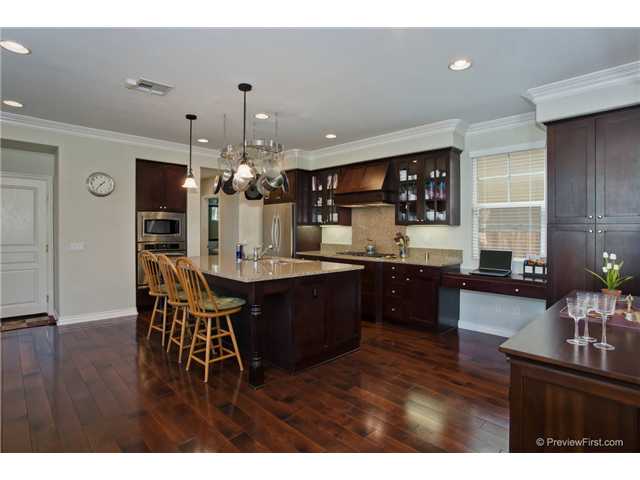 2681 Paradise Road Carlsbad, CA 92009 - Photo 10 of 23 This really shows off the gorgeous distressed wide plank wood flooring upgraded throughout the downstairs living area. Granite shines like the floors and wonderful crown molding ,high base board detail wi/ surround sound speakers in 11' ceilings