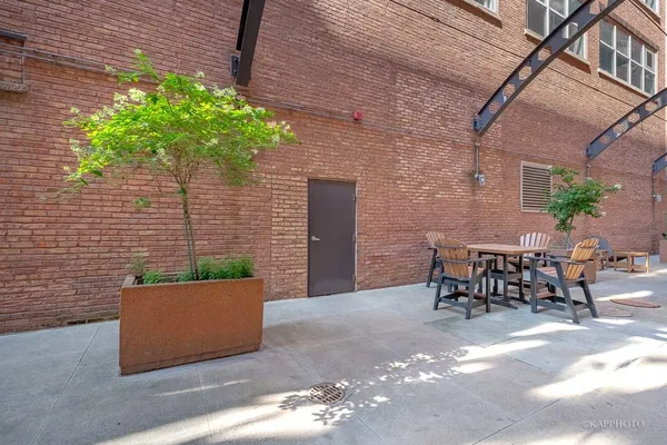 a view of a patio with table and chairs and potted plants