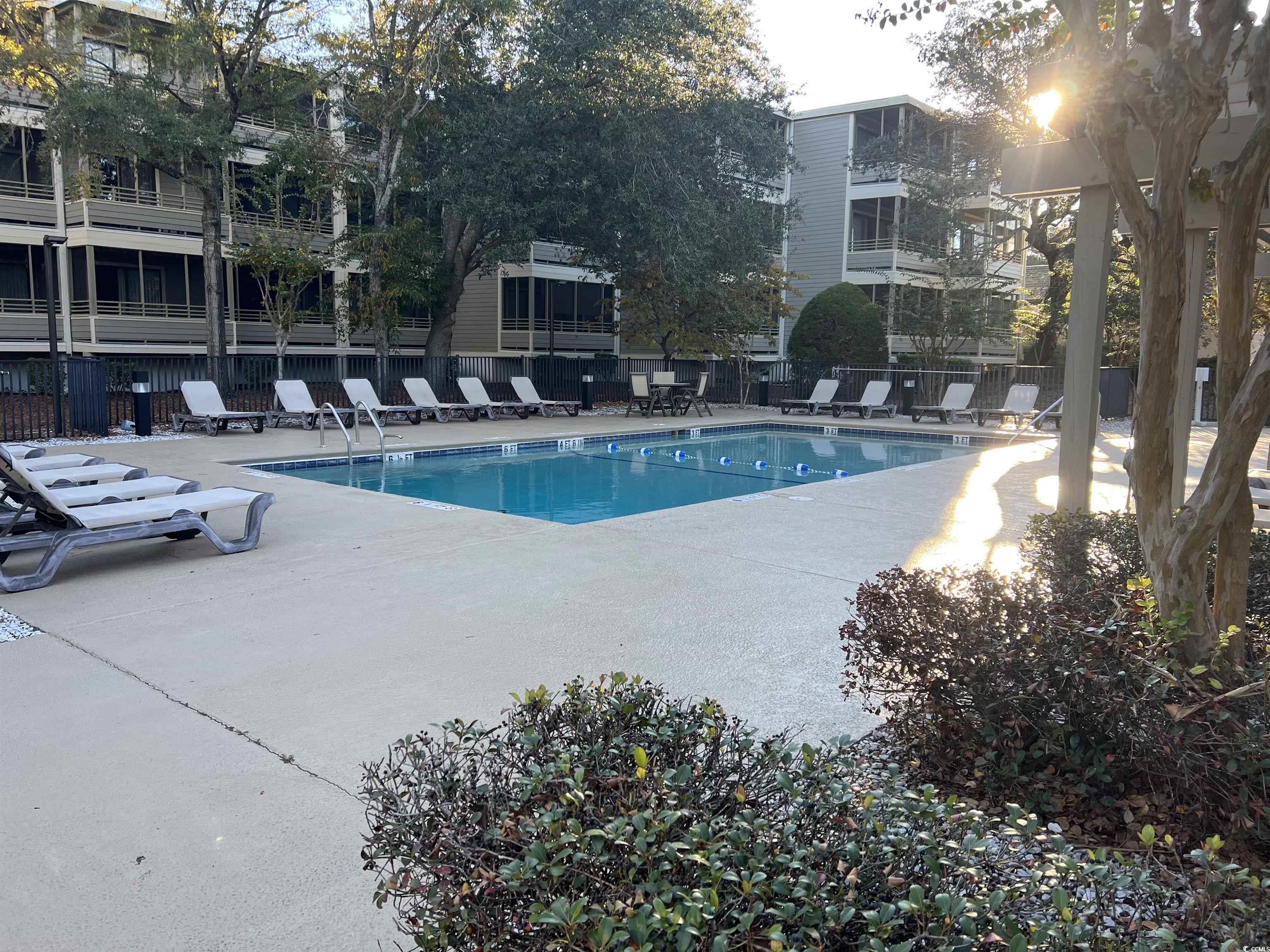 415 Ocean Creek Drive, Unit 2188 Myrtle Beach, SC 29572 - Photo 14 of 28 Community pool with a patio area and a pergola