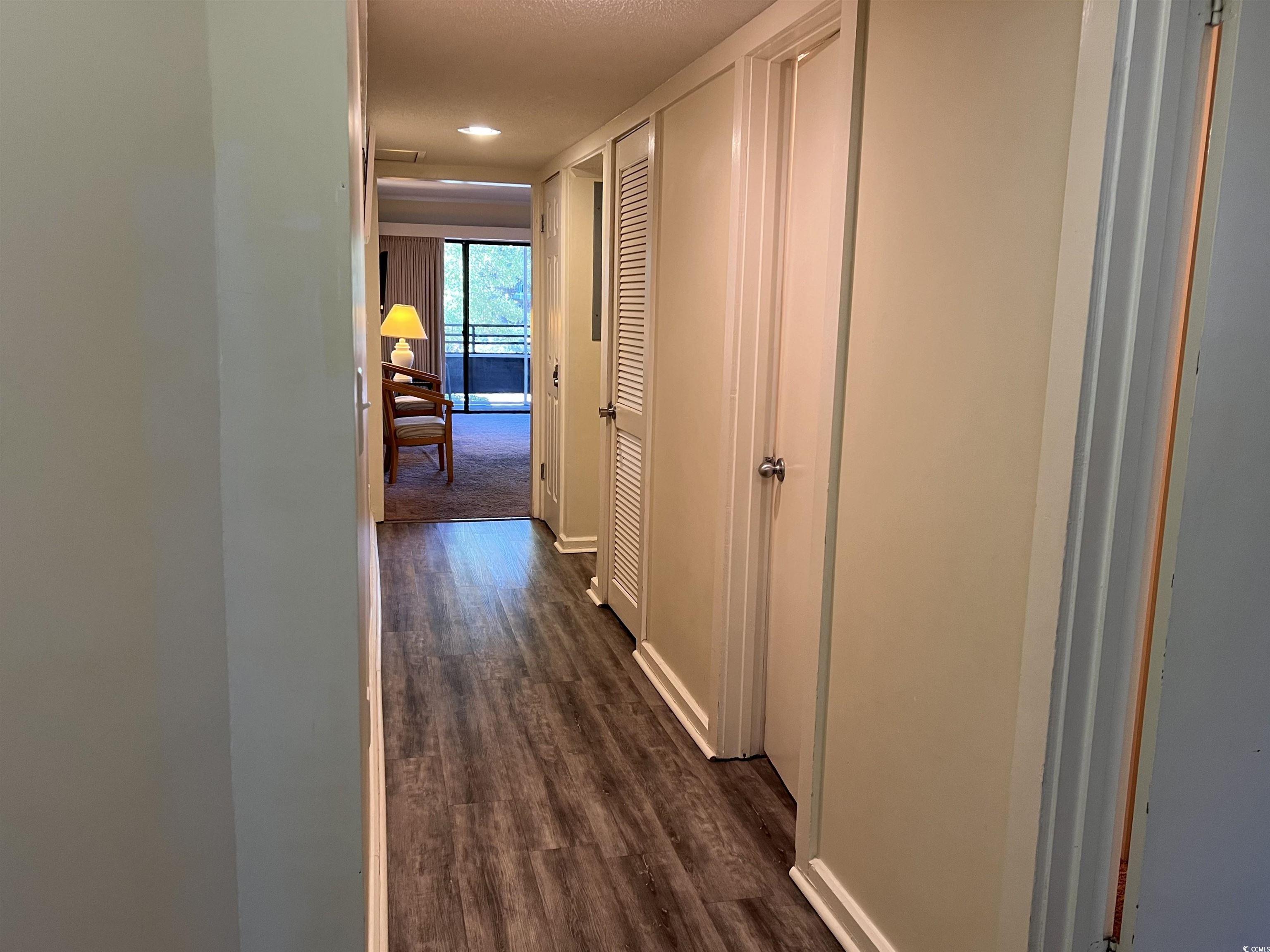 415 Ocean Creek Drive, Unit 2188 Myrtle Beach, SC 29572 - Photo 2 of 28 Hall with dark wood-type flooring and baseboards