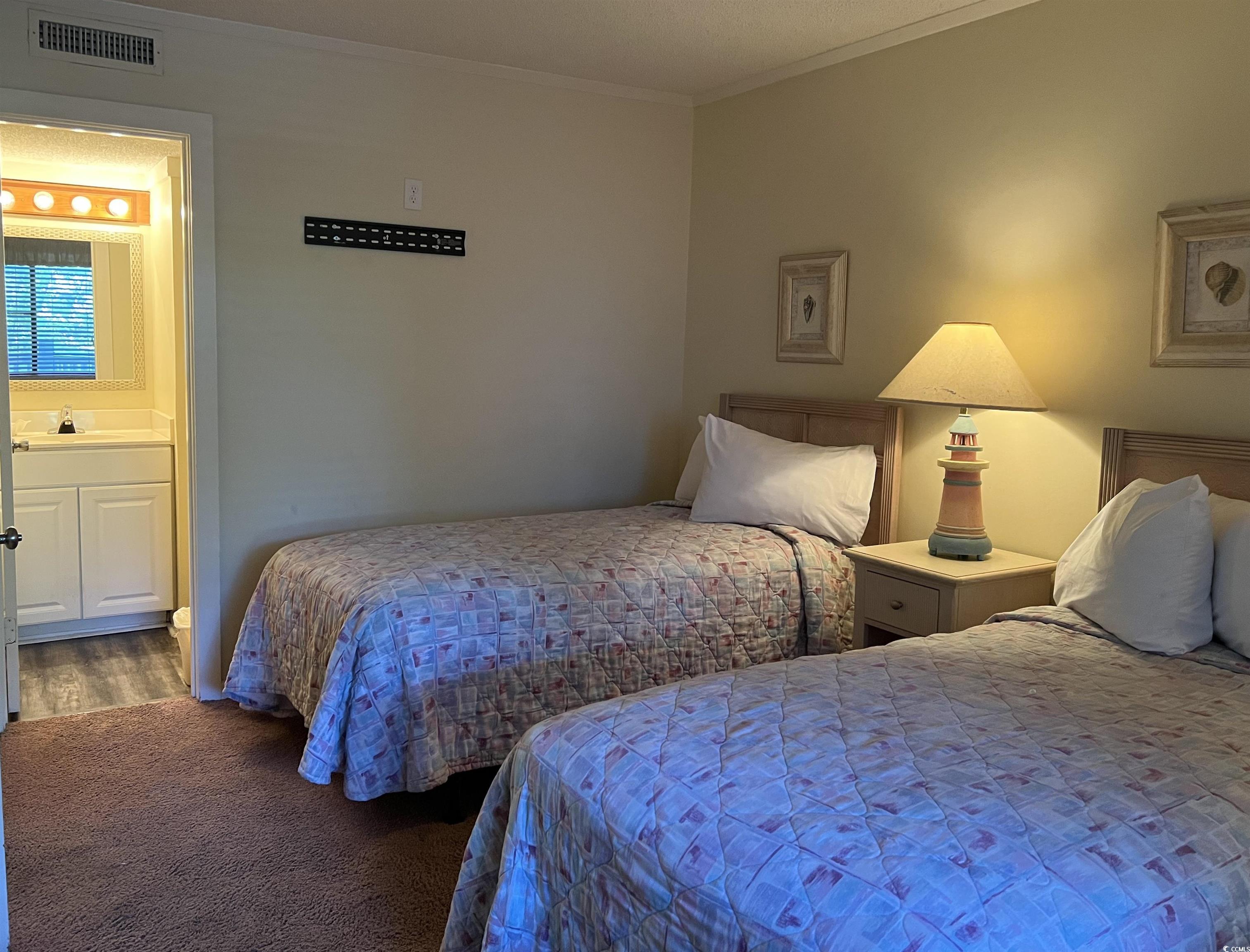 415 Ocean Creek Drive, Unit 2188 Myrtle Beach, SC 29572 - Photo 5 of 28 Bedroom with ornamental molding, carpet floors, and ensuite bathroom