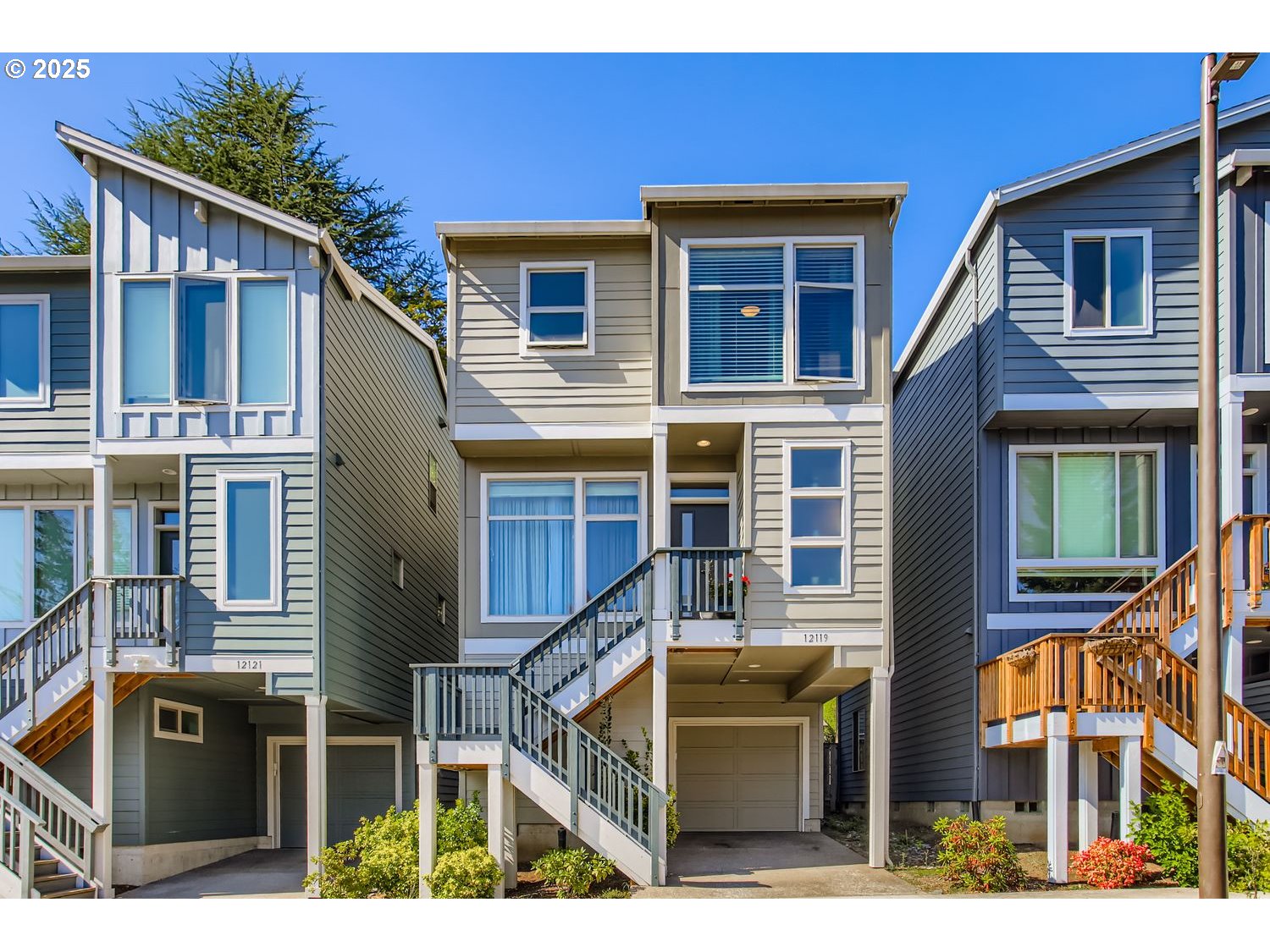 12119 Southwest Tesla Terrace Beaverton, OR 97008 - Photo 1 of 31 a front view of a house with many windows