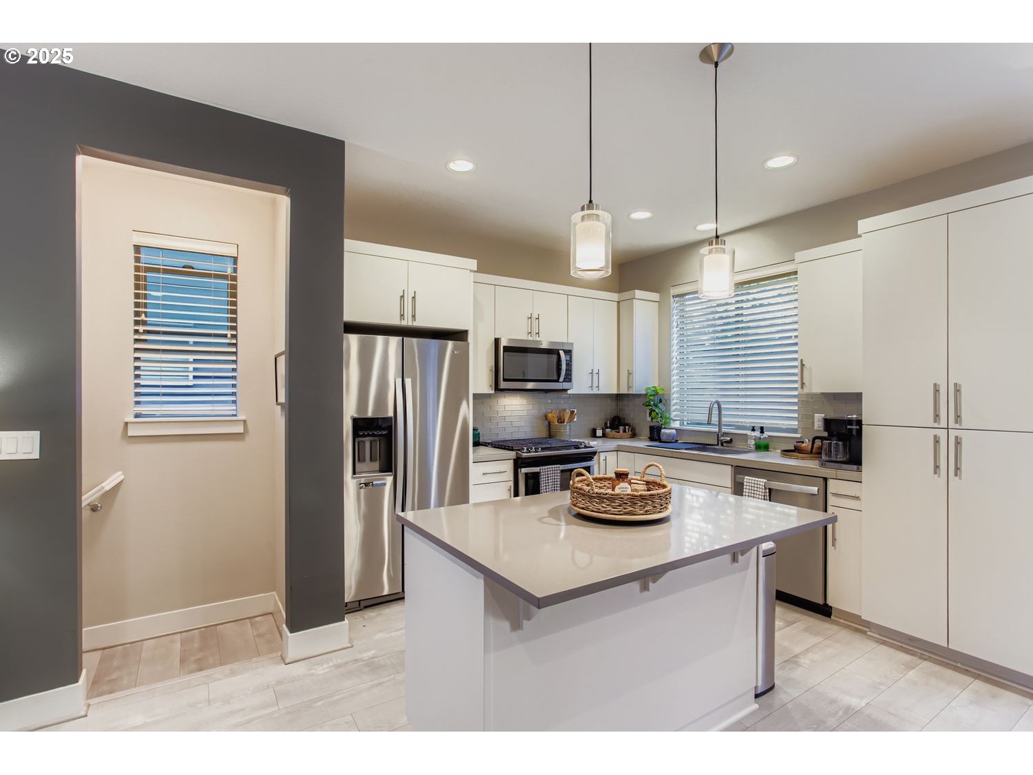 12119 Southwest Tesla Terrace Beaverton, OR 97008 - Photo 11 of 31 a kitchen with a refrigerator a stove a sink and chairs