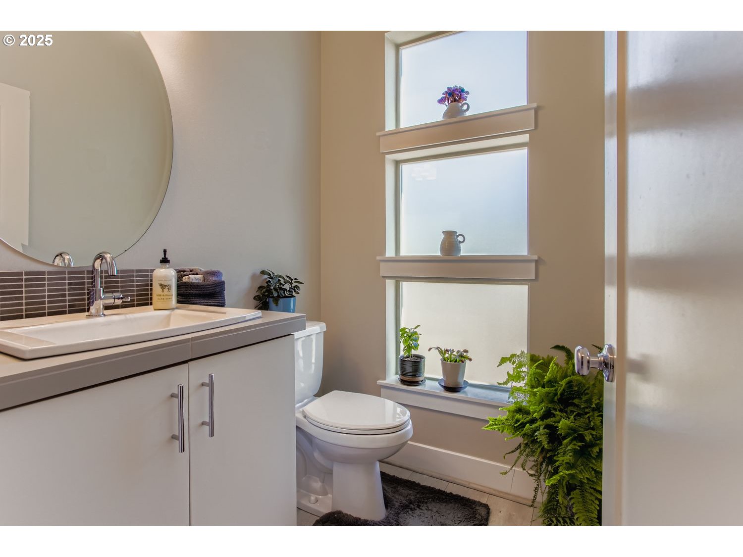 12119 Southwest Tesla Terrace Beaverton, OR 97008 - Photo 12 of 31 a bathroom with a toilet a sink and a mirror