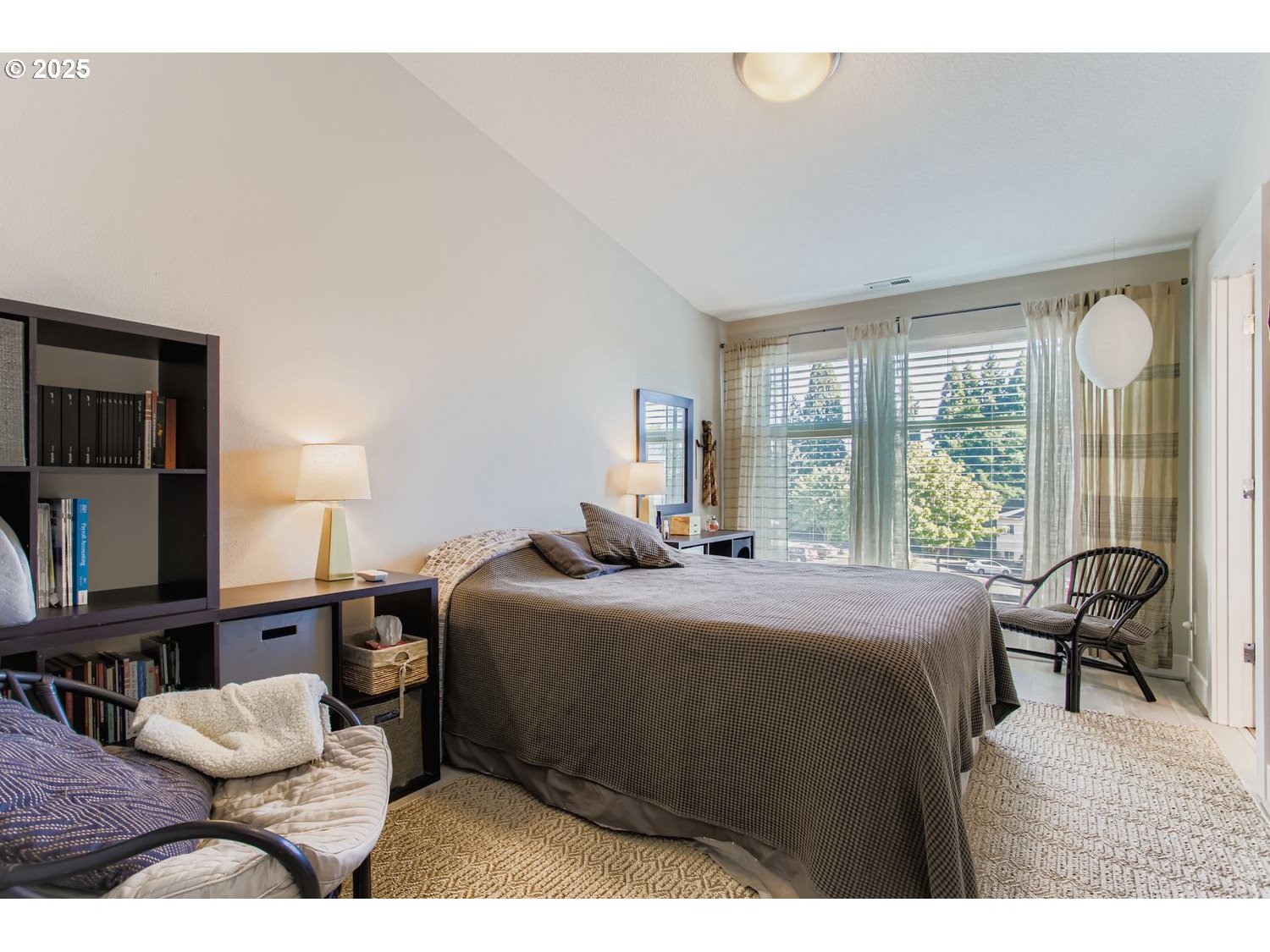 12119 Southwest Tesla Terrace Beaverton, OR 97008 - Photo 13 of 31 a bedroom with a bed mirror and a window