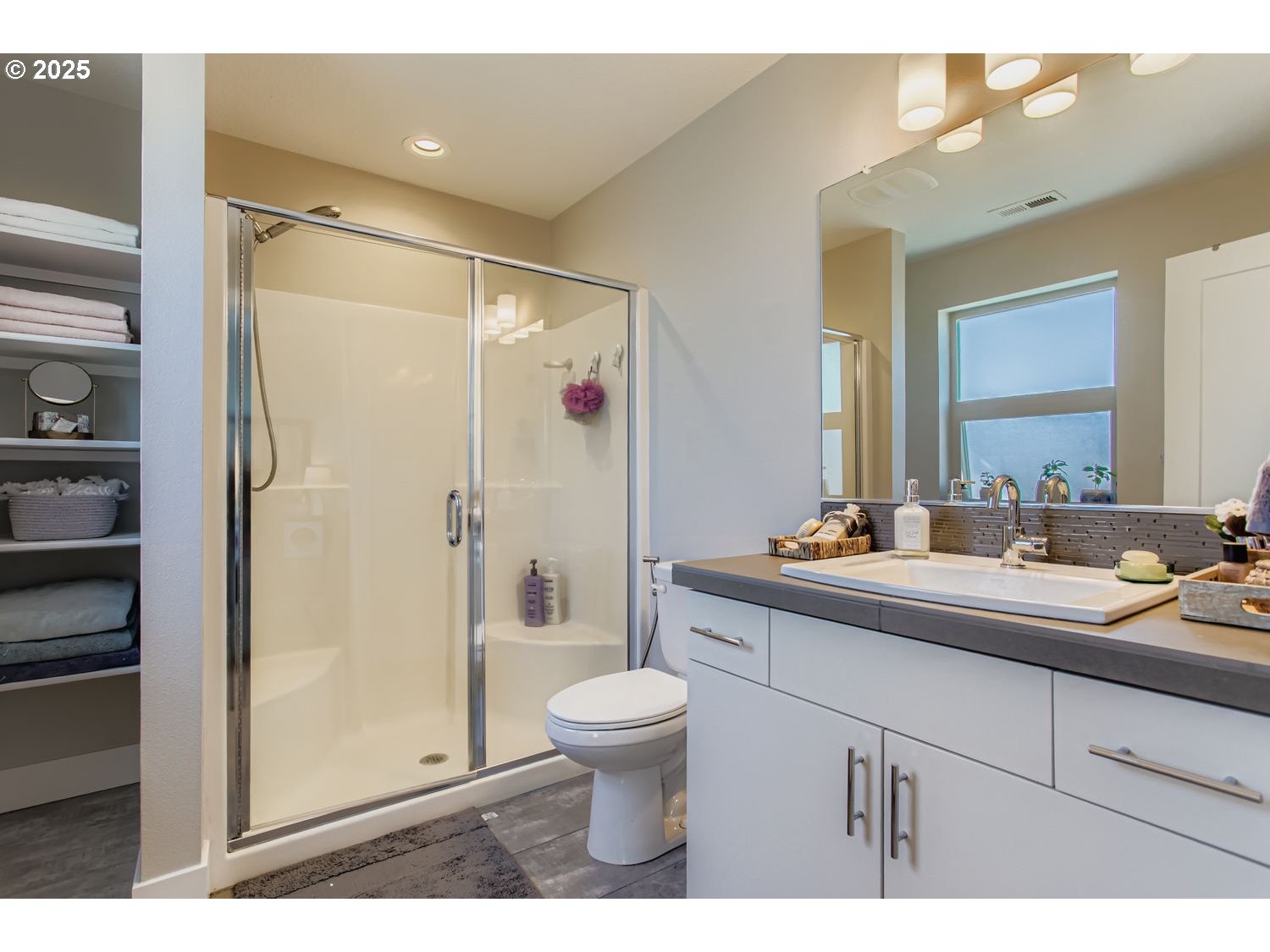 12119 Southwest Tesla Terrace Beaverton, OR 97008 - Photo 16 of 31 a bathroom with a sink a toilet and shower