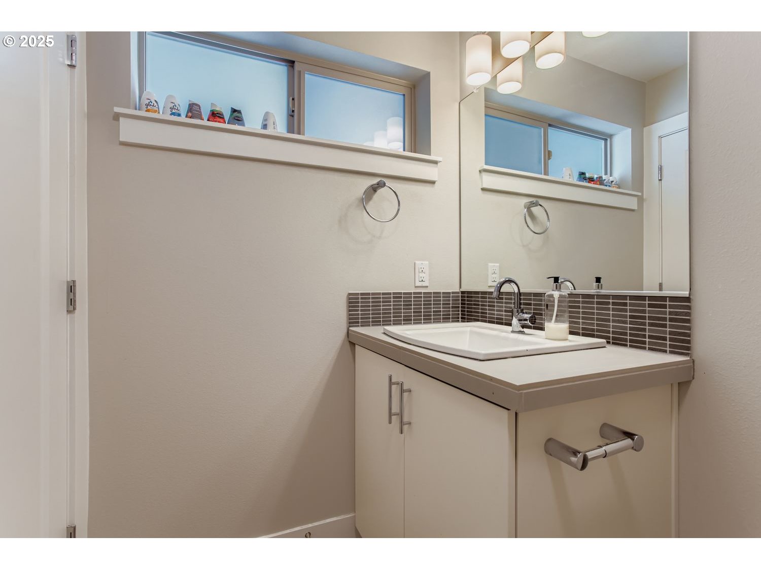 12119 Southwest Tesla Terrace Beaverton, OR 97008 - Photo 25 of 31 a bathroom with a sink and a mirror