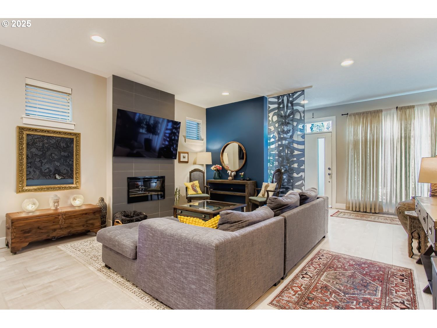 12119 Southwest Tesla Terrace Beaverton, OR 97008 - Photo 5 of 31 a living room with furniture a fireplace and a flat screen tv