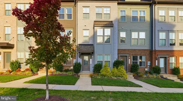 a front view of a residential apartment building with a yard