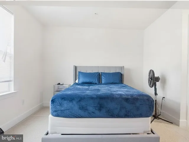 a bedroom with a bed and a window