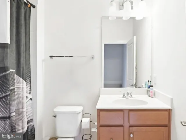 a bathroom with a sink toilet and mirror