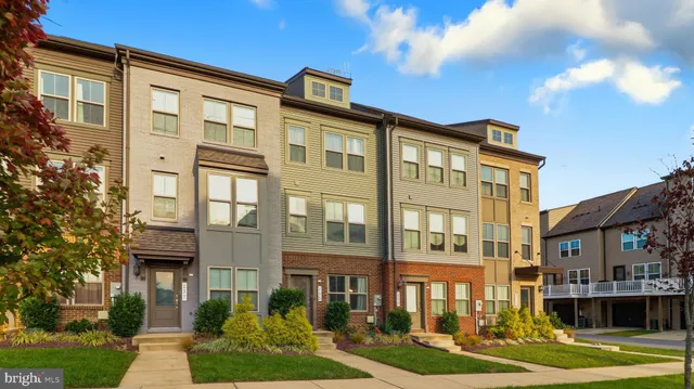 a front view of a residential apartment building with a yard