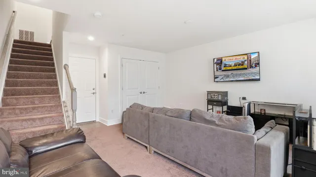 a living room with furniture and a stairs