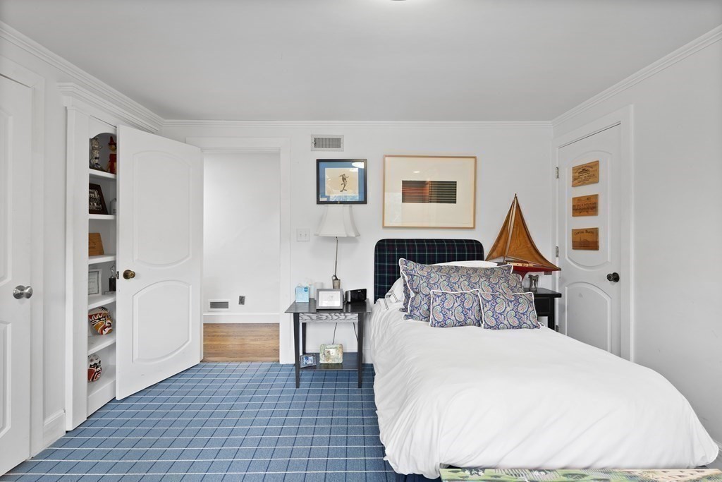 61 Cliff Road Weston, MA 02493 - Photo 21 of 28 a bedroom with a bed and a couch