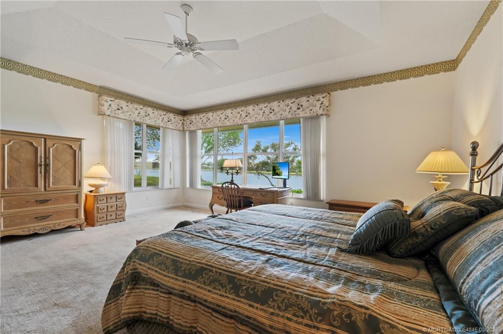 3510 Southeast Cambridge Drive Stuart, FL 34997 - Photo 16 of 38 Large primary bedroom with seating area and desk