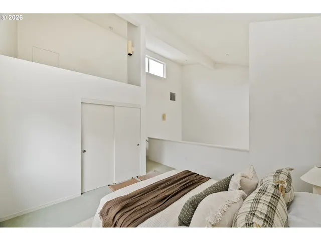 a bedroom with a bed and a night stand