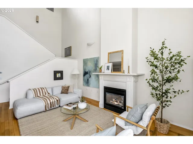 a living room with furniture a potted plant and a fireplace