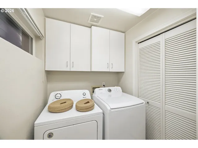 a living room with furniture a fireplace and a potted plant