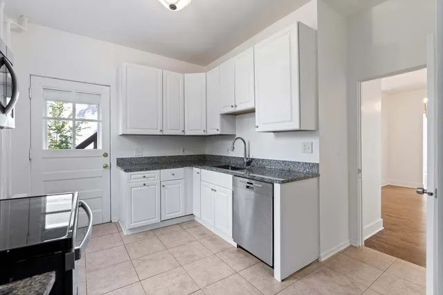 a kitchen with stainless steel appliances granite countertop a sink and cabinets
