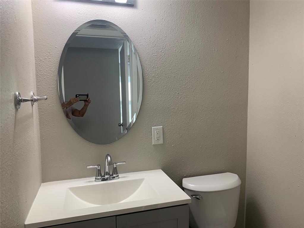 3756 Amherst Way, Unit 1 Sarasota, FL 34232 - Photo 13 of 14 a bathroom with a toilet sink and mirror