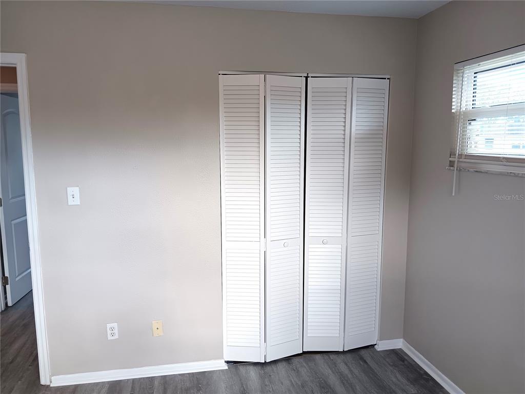 3756 Amherst Way, Unit 1 Sarasota, FL 34232 - Photo 6 of 14 an empty room with wooden floor and windows