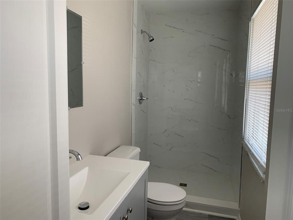 3756 Amherst Way, Unit 1 Sarasota, FL 34232 - Photo 9 of 14 a bathroom with a toilet and shower