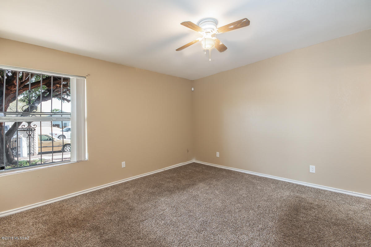 7761 North Rasmussen Avenue Tucson, AZ 85741 - Photo 10 of 23 an empty room with a window and a fan