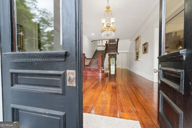 a room with white cabinets and black appliances