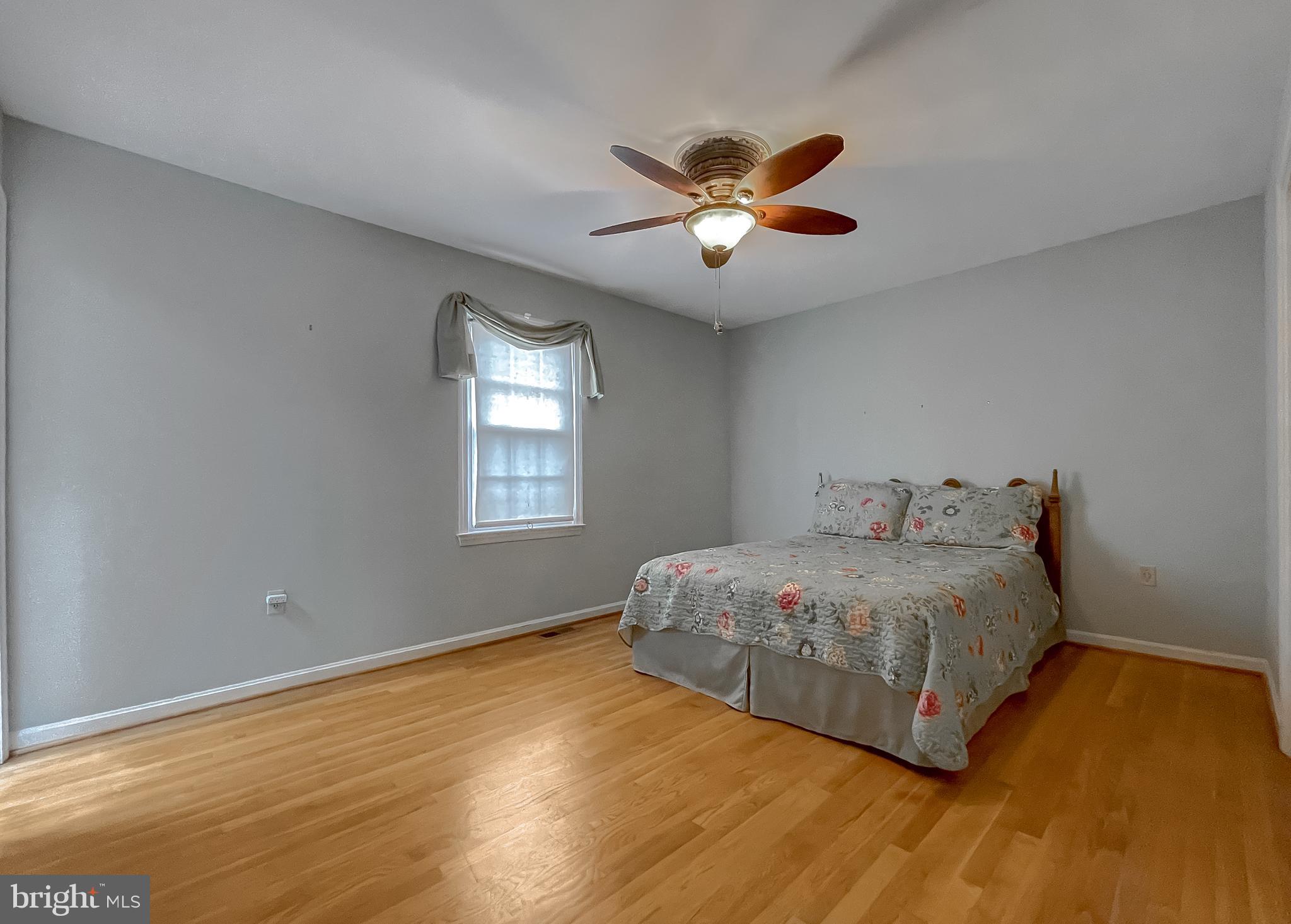 7004 Vismanco Lane Clinton, MD 20735 - Photo 22 of 63 a bedroom with a bed and a chandelier