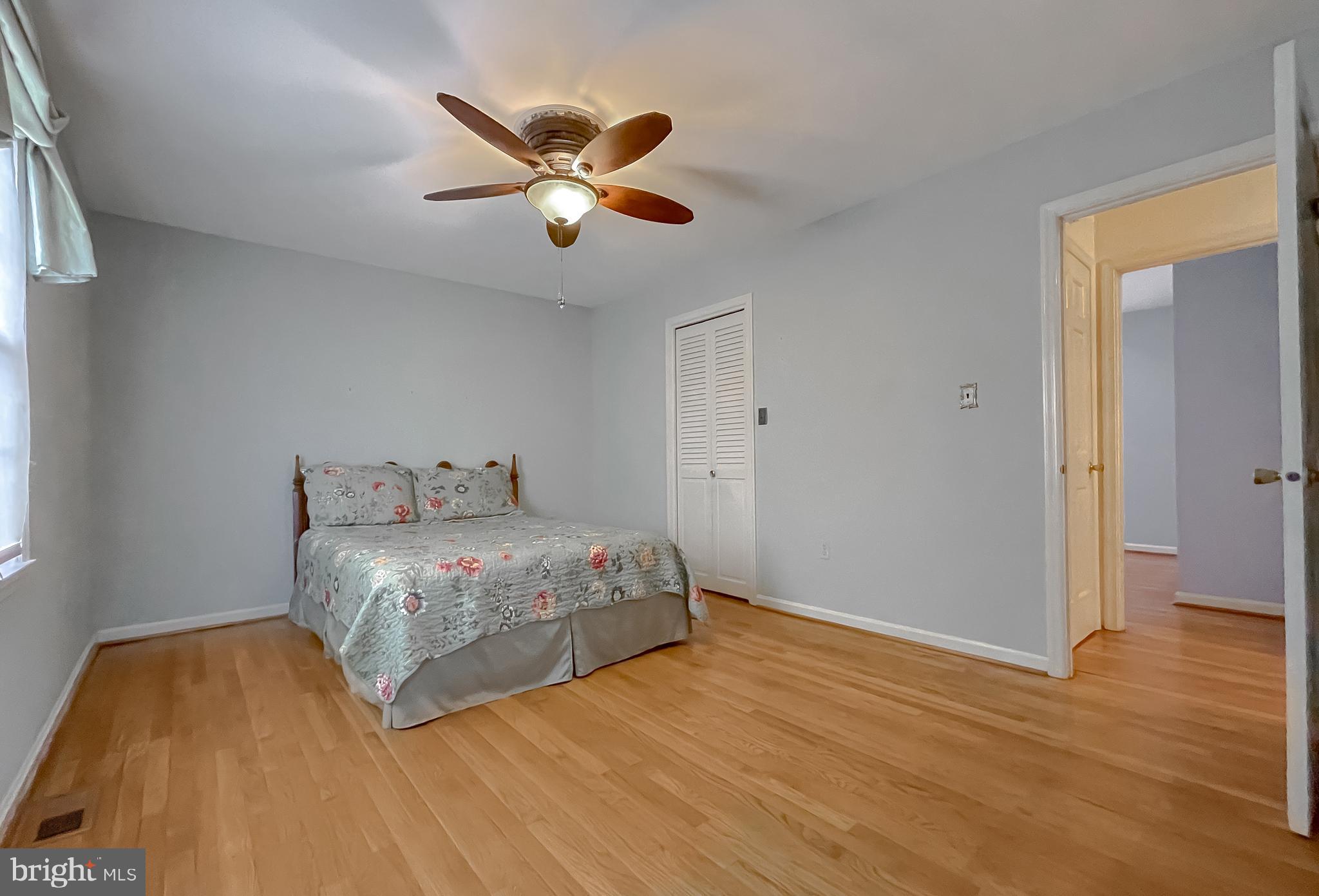 7004 Vismanco Lane Clinton, MD 20735 - Photo 23 of 63 a bedroom with a bed and wooden floor