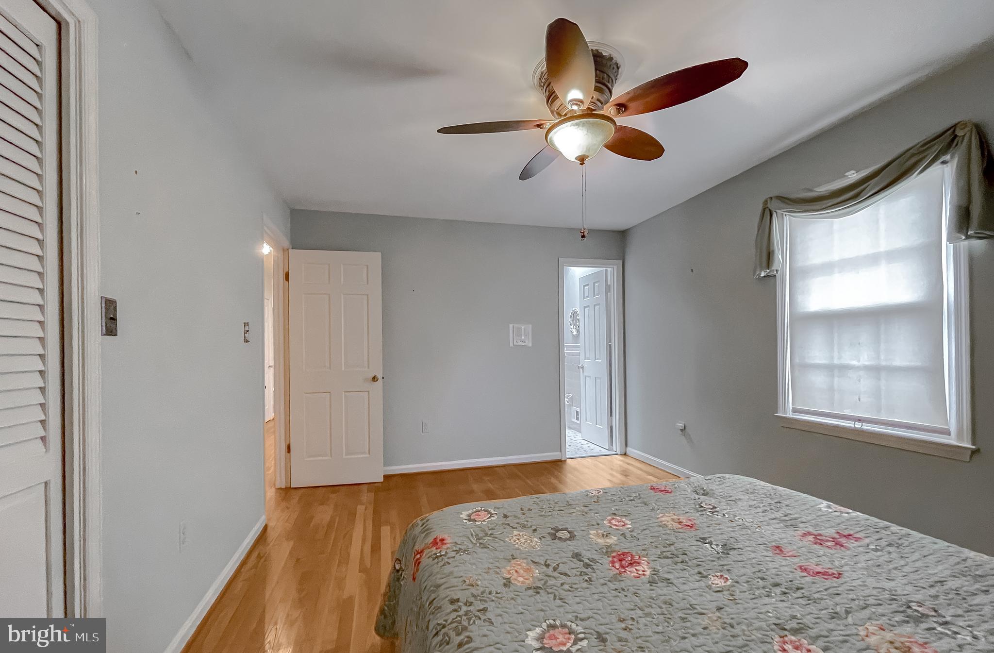 7004 Vismanco Lane Clinton, MD 20735 - Photo 25 of 63 a bedroom with a bed and a chandelier