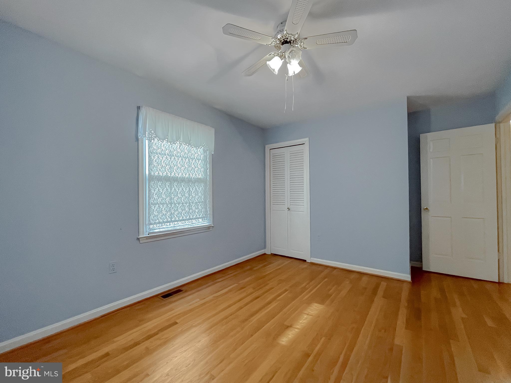 7004 Vismanco Lane Clinton, MD 20735 - Photo 31 of 63 a view of empty room with wooden floor and fan